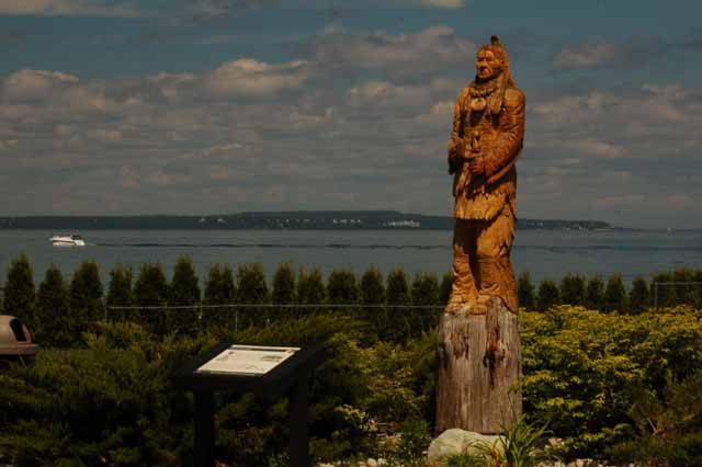 Mackinac Island in the background, Chief Wawatam statue in foreground